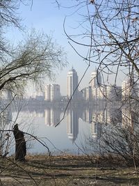 River and buildings against sky