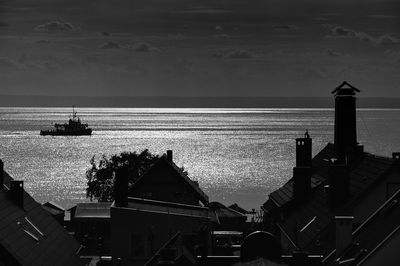 High angle view of sea by buildings against sky