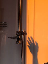 Shadow of cropped hand in bathroom