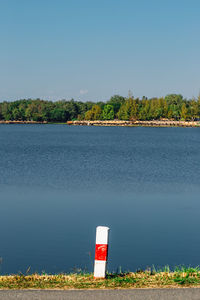 Scenic view of lake against clear blue sky