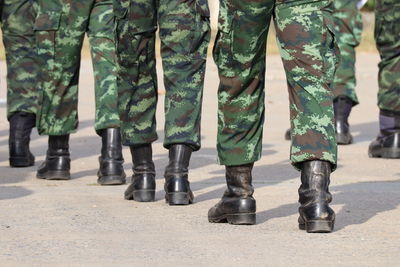 Low section of soldiers walking on street