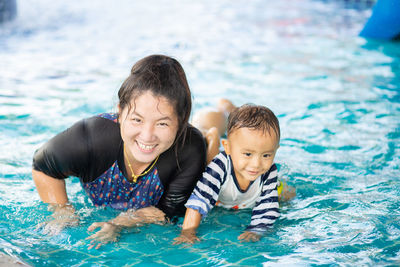 Portrait of boy swimming in pool