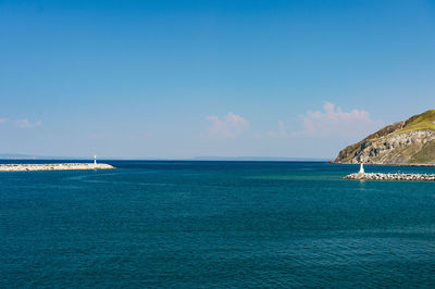 Scenic view of sea against blue sky