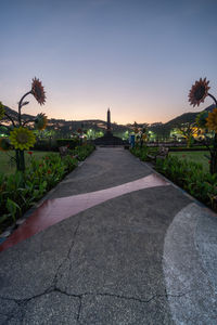 View of footpath against sky during sunset