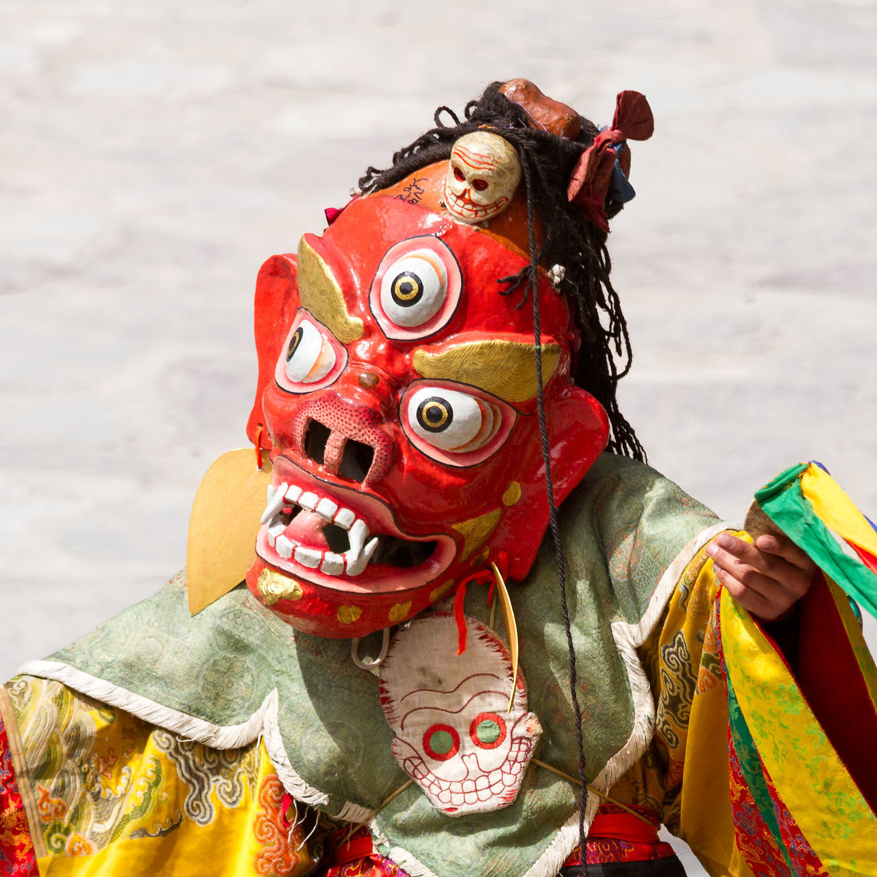 CLOSE-UP OF STATUE WITH TOY AGAINST RED BACKGROUND