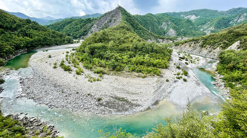 Scenic view of river amidst mountains