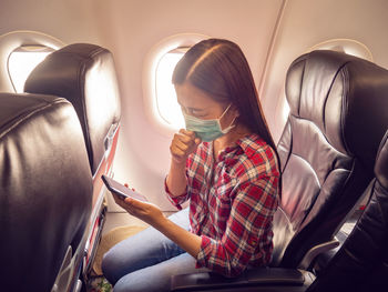 Midsection of woman holding mobile phone