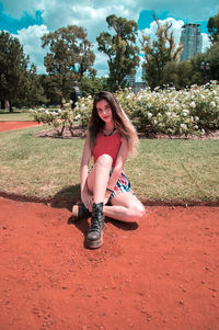 Portrait of smiling young woman sitting outdoors