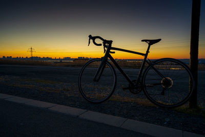 Low section of man riding bicycle on street