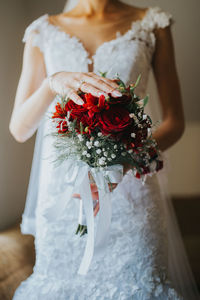 Midsection of woman holding bouquet