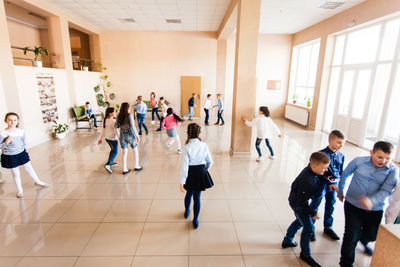 Group of people standing on tiled floor