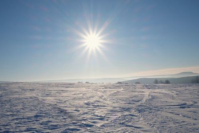 Scenic view of snow covered landscape against sky