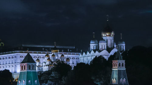 Illuminated buildings of moscow kremlin against sky at night