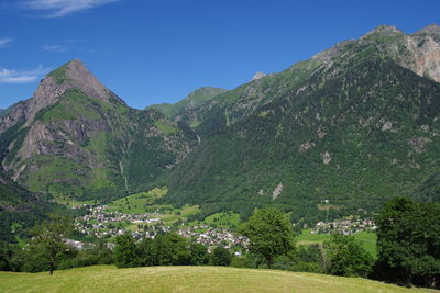 Scenic view of mountains against blue sky