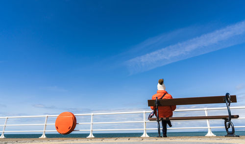 Woman on beach against sky