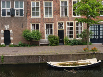 Canal by building in city