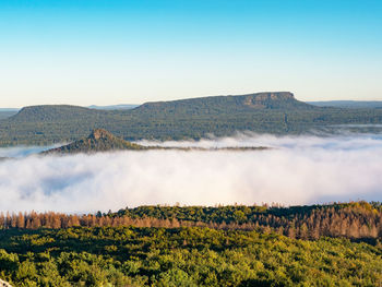 Zirkelstein, behind kleiner zschirnstein and grosser zschirnstein with autumn fog, white waves