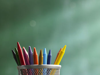 Close-up of colorful crayons in desk organizer