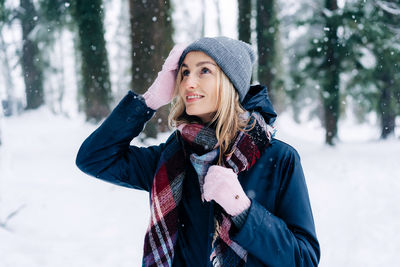 Portrait of a woman on a winter day standing outside in winter clothes.