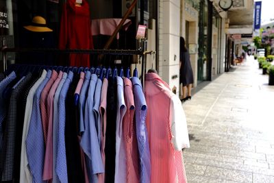 Multi colored clothes hanging on rack in store