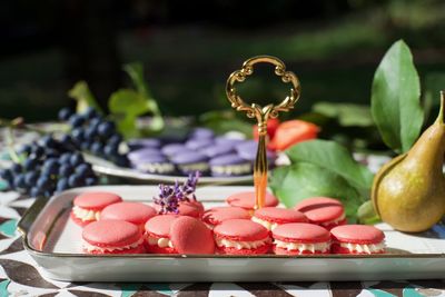 Close-up of macarons and fruits on table