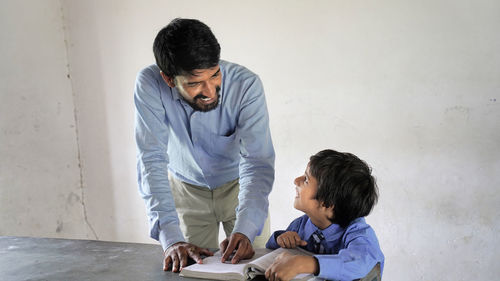 Side view of young man working at home
