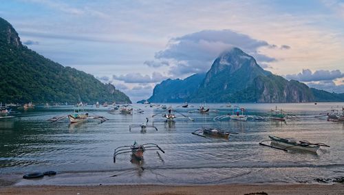 Scenic view of sea and mountains against sky