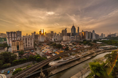 High angle view of city buildings against sky during sunset