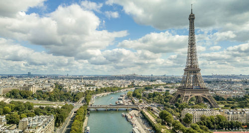 Aerial view of city against cloudy sky