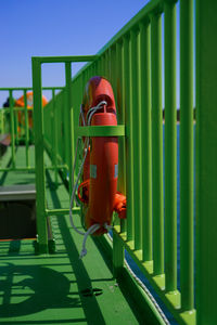 Close-up of red metal structure against sky