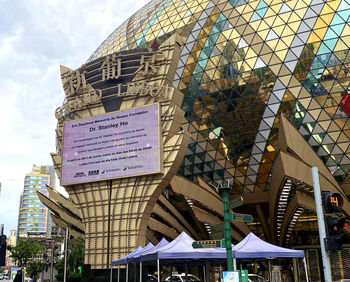 Low angle view of text on building against sky