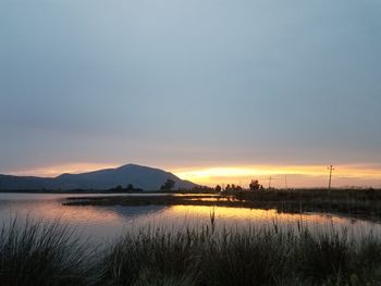 Scenic view of lake against sky during sunset