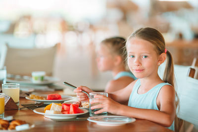 Portrait of woman sitting with food