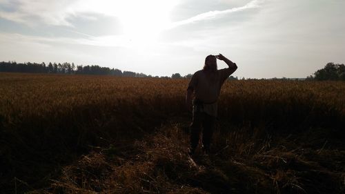 Man standing on field against sky