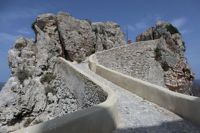 Rock formation on mountain against sky