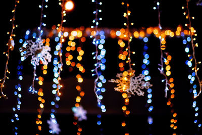 Close-up of illuminated christmas lights at night