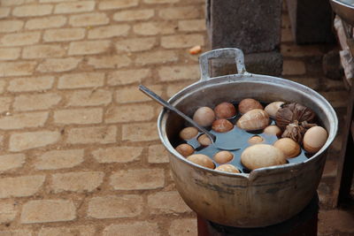 Close-up of boiled eggs in cooking pot for sale on street
