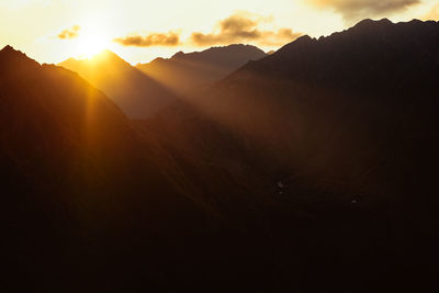 Scenic view of mountains against sky during sunset