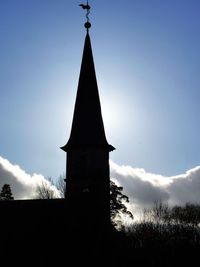 Low angle view of silhouette building against sky