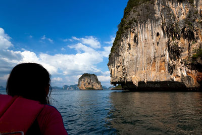 Rear view of woman looking at sea against sky