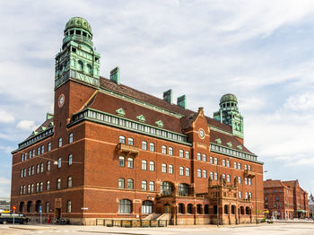 Low angle view of building against cloudy sky