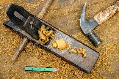 High angle view of carpentry tools and wood shavings on table