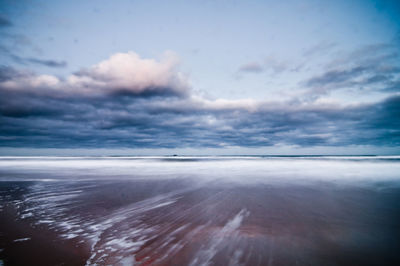 Scenic view of sea against cloudy sky