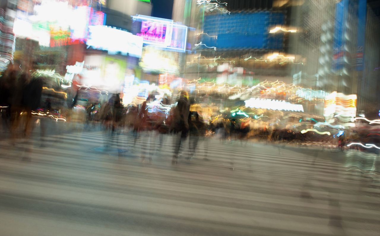 BLURRED MOTION OF ILLUMINATED BUILDINGS AT NIGHT