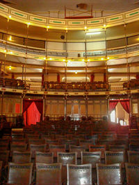 Empty chairs and tables in illuminated building