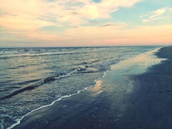 Scenic view of beach against sky during sunset