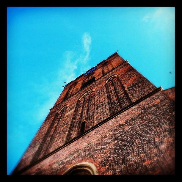 architecture, building exterior, built structure, low angle view, transfer print, auto post production filter, sky, blue, building, brick wall, tower, high section, window, outdoors, day, no people, old, wall - building feature, cloud, residential structure