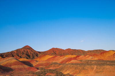 Scenic view of mountains against clear blue sky