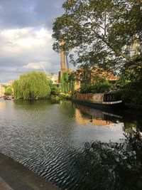 Scenic view of river by trees against sky