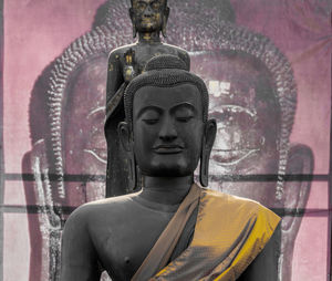 Statue of buddha against building
